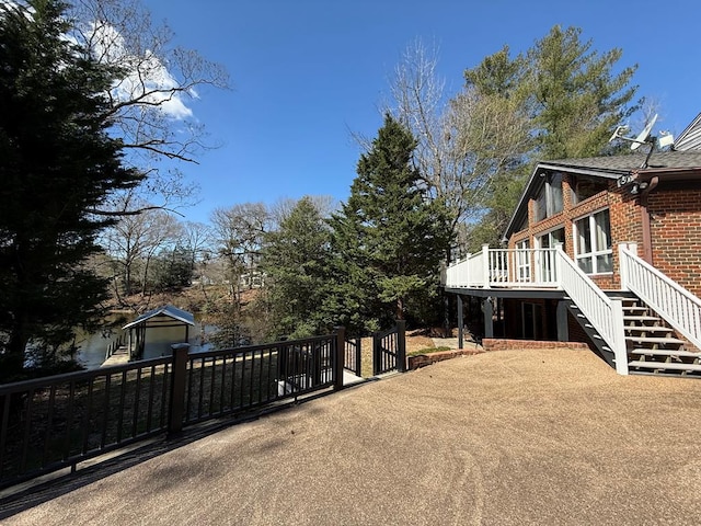 view of yard with a deck and stairs