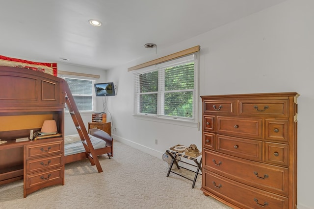 bedroom with recessed lighting, multiple windows, light colored carpet, and baseboards