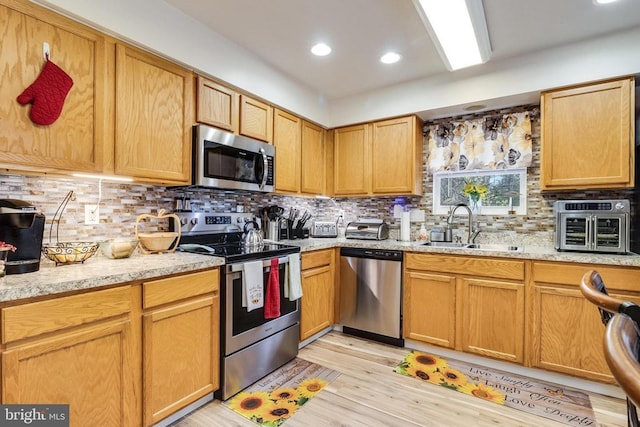 6 Dockside Ct, Montross, VA 22520 - kitchen with a sink, decorative backsplash, stainless steel appliances, and light wood-style flooring
