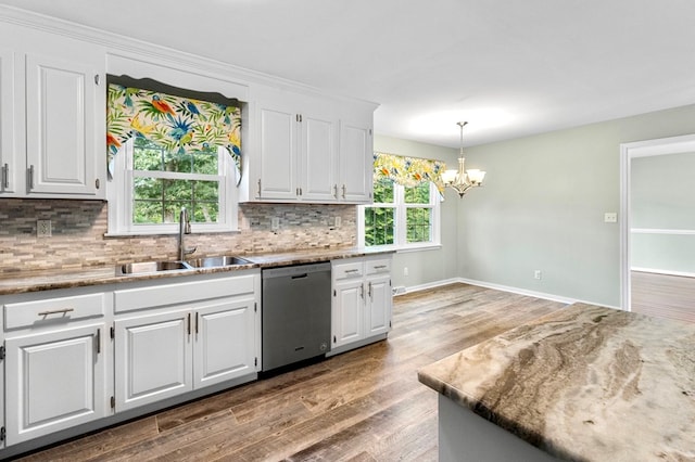 kitchen with sink, decorative light fixtures, stainless steel dishwasher, and white cabinets