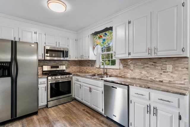 kitchen with sink, white cabinetry, stainless steel appliances, dark hardwood / wood-style floors, and tasteful backsplash