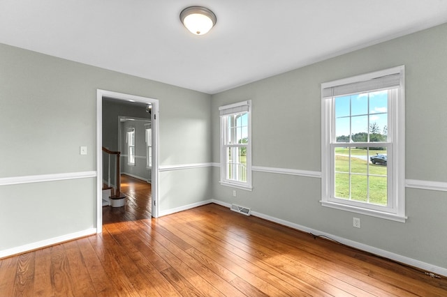 unfurnished room with hardwood / wood-style floors and a wealth of natural light