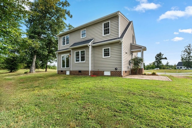 rear view of property with a lawn