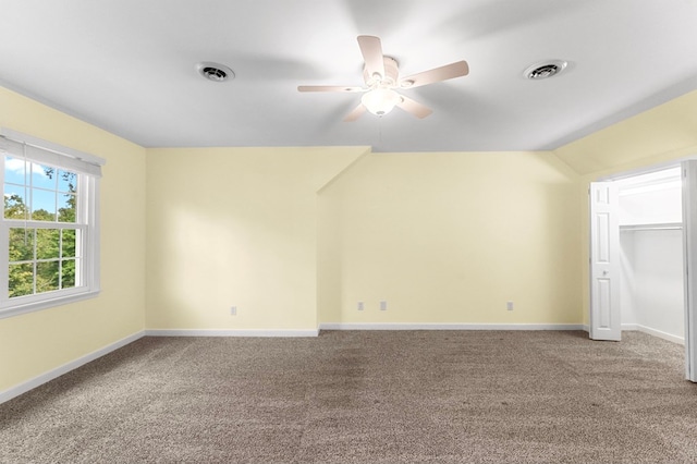 interior space with vaulted ceiling, ceiling fan, and carpet floors