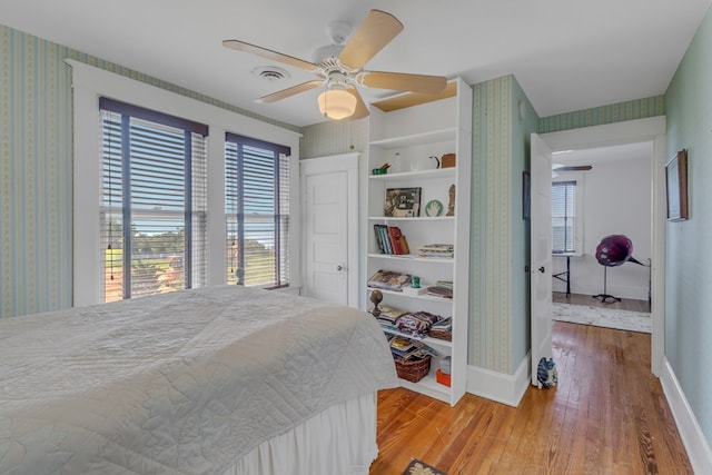 bedroom with ceiling fan and hardwood / wood-style floors