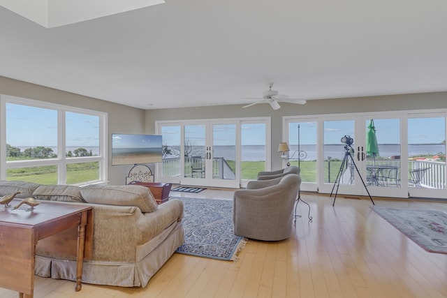 living room featuring ceiling fan and light hardwood / wood-style floors