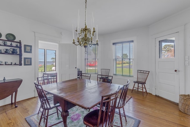 dining room featuring light hardwood / wood-style floors and a notable chandelier