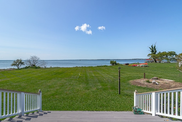 view of yard with a deck with water view