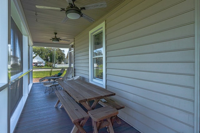 wooden terrace with ceiling fan and covered porch