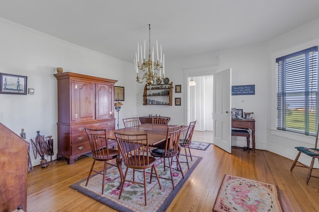 dining room with a chandelier, a wealth of natural light, and light hardwood / wood-style flooring