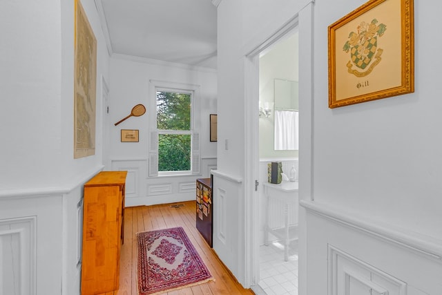 19 Cedardale Ln, Irvington, VA 22480 - doorway featuring light wood-type flooring, a wainscoted wall, a decorative wall, and ornamental molding