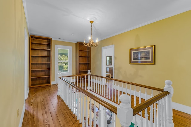 19 Cedardale Ln, Irvington, VA 22480 - corridor featuring an upstairs landing, a chandelier, wood-type flooring, and ornamental molding