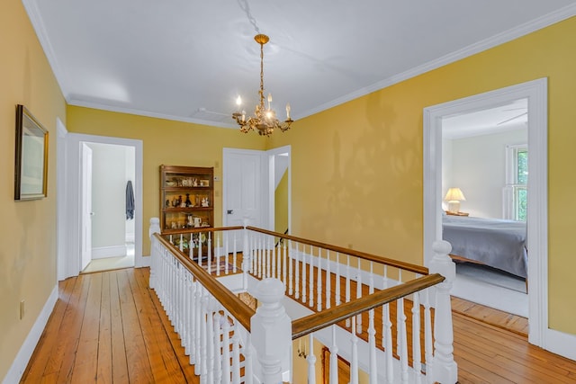 19 Cedardale Ln, Irvington, VA 22480 - hallway with an upstairs landing, wood-type flooring, a chandelier, and ornamental molding