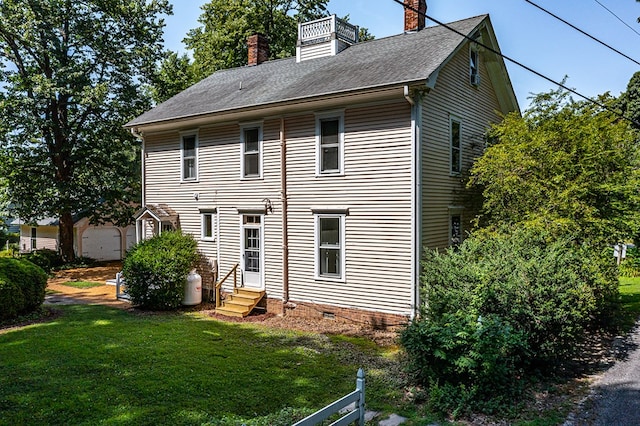 19 Cedardale Ln, Irvington, VA 22480 - rear view of house with entry steps, a chimney, a lawn, and a shingled roof