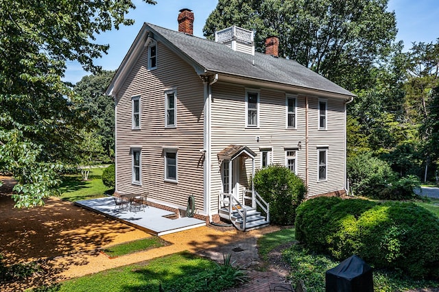 19 Cedardale Ln, Irvington, VA 22480 - rear view of property featuring a chimney, a patio area, and a yard
