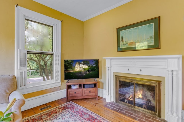 19 Cedardale Ln, Irvington, VA 22480 - living room with a fireplace with flush hearth, hardwood / wood-style flooring, and crown molding