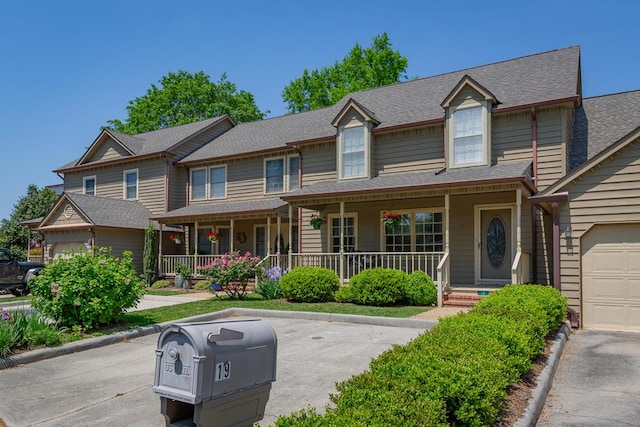 view of front of house featuring a porch and a garage