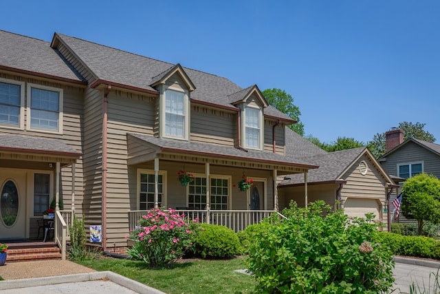 view of front of home with a porch and a garage