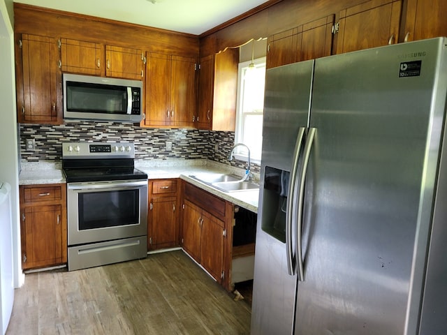 467 The Hook Rd, Warsaw, VA 22572 - kitchen with stainless steel appliances, brown cabinetry, and light countertops