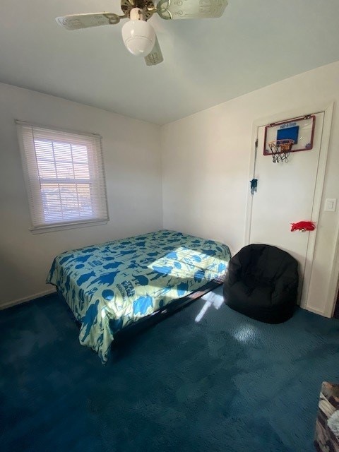 bedroom with ceiling fan and carpet flooring