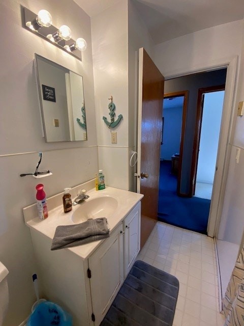 half bathroom with toilet and vanity