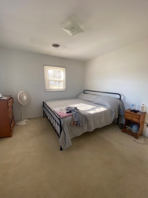 bedroom with light colored carpet and visible vents