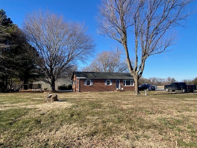 view of front of home featuring a front lawn and brick siding