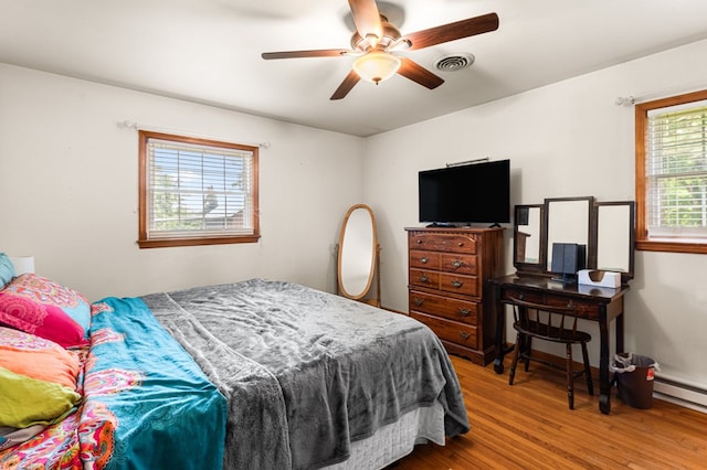 31 Bunker Hill Rd, Farnham, VA 22460 - bedroom with wood finished floors, a baseboard radiator, and a ceiling fan