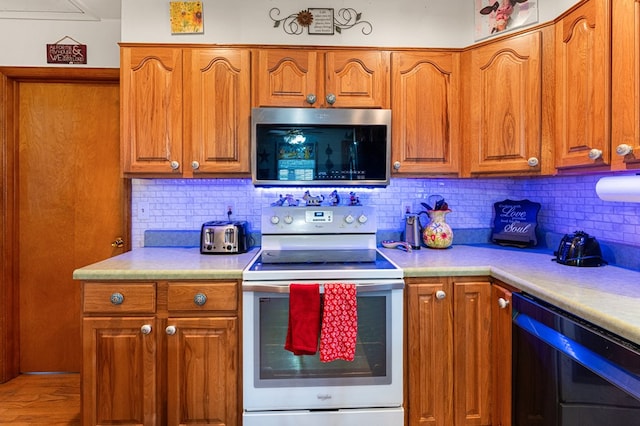 31 Bunker Hill Rd, Farnham, VA 22460 - kitchen featuring stainless steel microwave, white electric range oven, dishwashing machine, and brown cabinetry