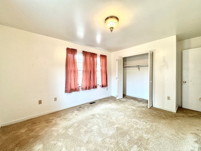 unfurnished bedroom featuring a closet and carpet floors