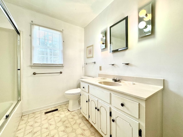 full bathroom featuring shower / bath combination with glass door, vanity, and toilet