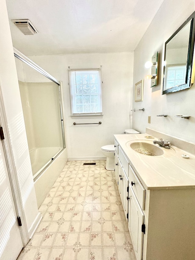 full bathroom with shower / bath combination with glass door, vanity, and toilet