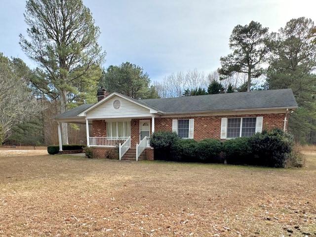 ranch-style house with a front yard and a porch