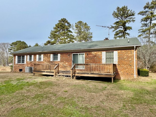 back of property with a yard, a deck, and central air condition unit