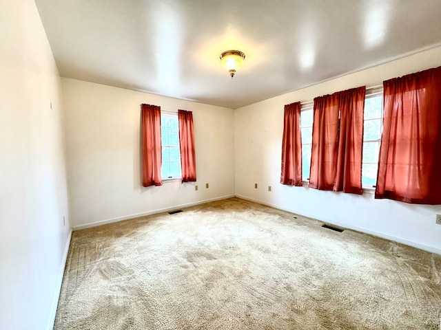 unfurnished room featuring carpet floors and a healthy amount of sunlight