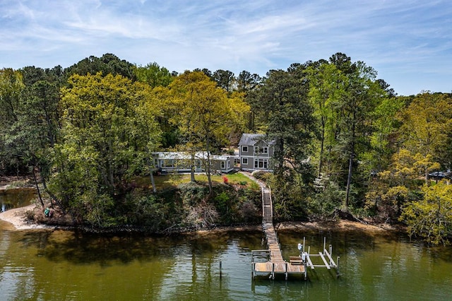 exterior space with a forest view, a water view, and boat lift