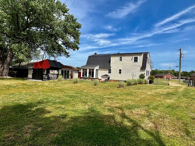 rear view of property with a yard