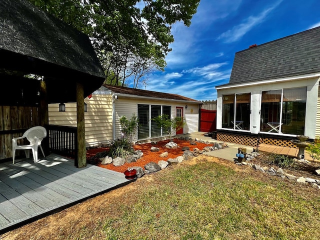 back of house with a yard and a wooden deck