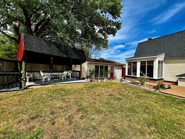 view of yard featuring a patio area and a sunroom