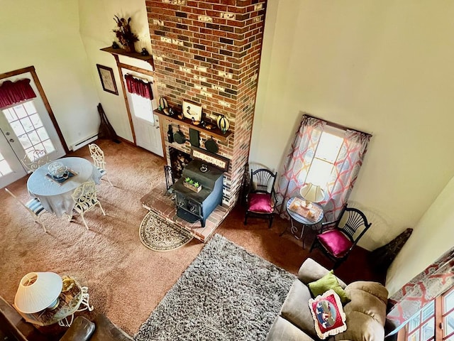 carpeted living room with a baseboard heating unit