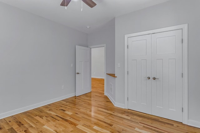 282 Regina Rd, Lancaster, VA 22503 - unfurnished bedroom with light wood-style floors, baseboards, a ceiling fan, and a closet