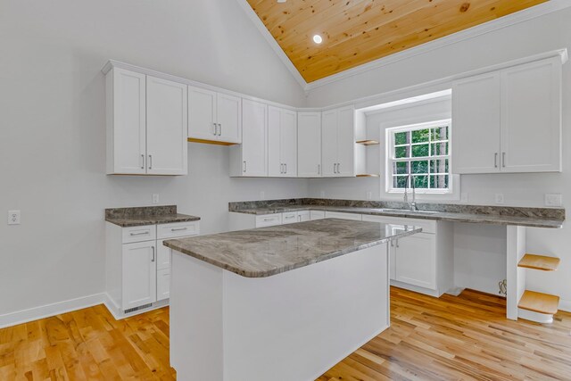 282 Regina Rd, Lancaster, VA 22503 - kitchen featuring a sink, wooden ceiling, light wood-style flooring, stone counters, and white cabinetry