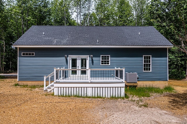 282 Regina Rd, Lancaster, VA 22503 - back of house featuring a deck, central air condition unit, a shingled roof, and view of wooded area