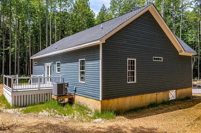 282 Regina Rd, Lancaster, VA 22503 - view of side of property featuring central AC, a wooden deck, and roof with shingles