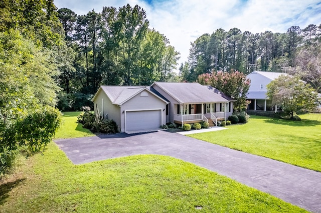 ranch-style home with a garage, covered porch, and a front yard