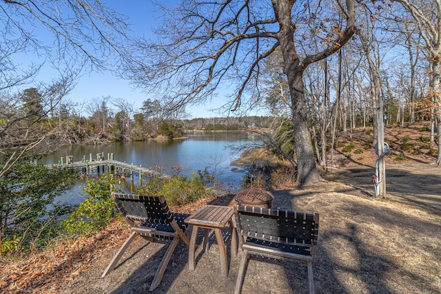 view of property's community featuring a water view and an outdoor fire pit