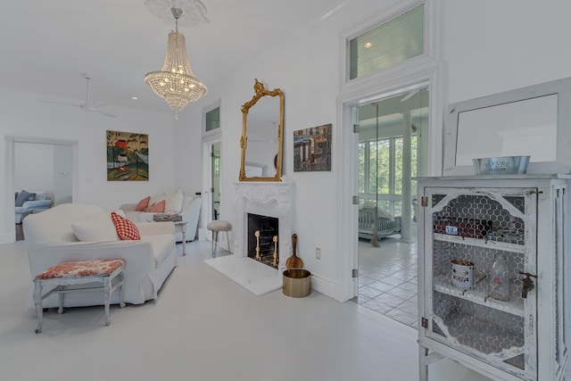 living area with a premium fireplace, a chandelier, and crown molding