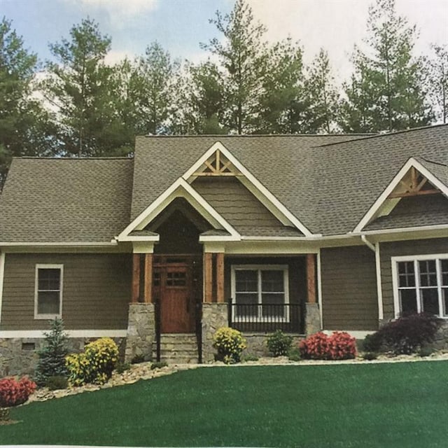 craftsman-style house with a front lawn and covered porch