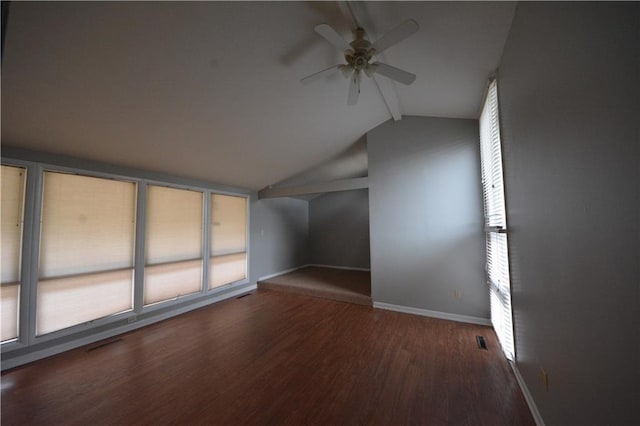 bonus room featuring a healthy amount of sunlight, ceiling fan, and dark hardwood / wood-style flooring