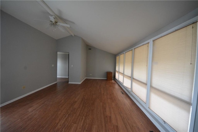 additional living space with vaulted ceiling with beams, ceiling fan, and dark hardwood / wood-style flooring